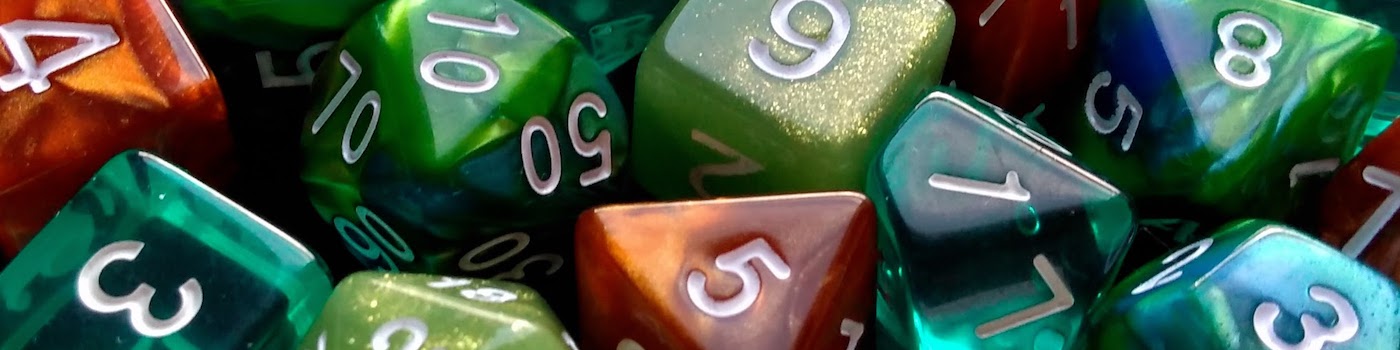 A close photo of green, teal, blue, and copper-coloured polyhedral dice